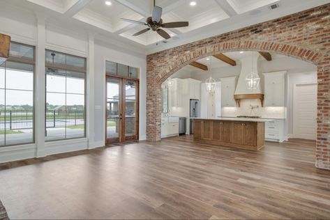 Fireplace Between Kitchen And Living, Exposed Brick Interior, Vaulted Ceiling Ideas, Kitchen Opening, Metal Building House Plans, Decorative Columns, Cc Furniture, Brick Interior, Brown Doors