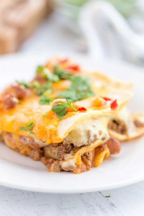 Mexican Lasagna with stacked tortillas, seasoned ground beef, beans, Rotel tomatoes, and cheese! Cheese Enchilada Casserole, Cream Cheese Enchiladas, Mexican Lasagna Recipes, Taco Lasagna, Mexican Lasagna, Cheese Enchiladas, Mexican Tacos, Colby Jack, Beef Enchiladas