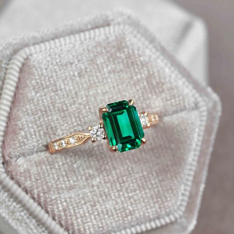 "An Art deco emerald cut Emerald and round diamond ring handmade in solid Rose Gold. The center emerald cut Emerald stone is 8 x 6mm and 1.51ct enclose by 2mm and 1mm and round diamonds. ✯ ✯✯ Free UK and USA shipping ✯✯ ✯ ✯✯ ✯ No Custom Charges for USA orders ✯✯ ✯ If you have any additional questions about this item, just hit the \"Ask a Question\" button (just to the right of the price) and I will get back to you within 24 hours. MADE TO ORDER Please allow 2 to 3 weeks to make this ring. Rush/d Art Deco Engagement Ring Emerald, Tsavorite Engagement Ring, Vintage Promise Ring, Classy Engagement Ring, Emerald Anniversary, Emerald Engagement Ring Green, Round Diamond Wedding Rings, Vintage Anniversary Rings, Wedding Rings Emerald Cut