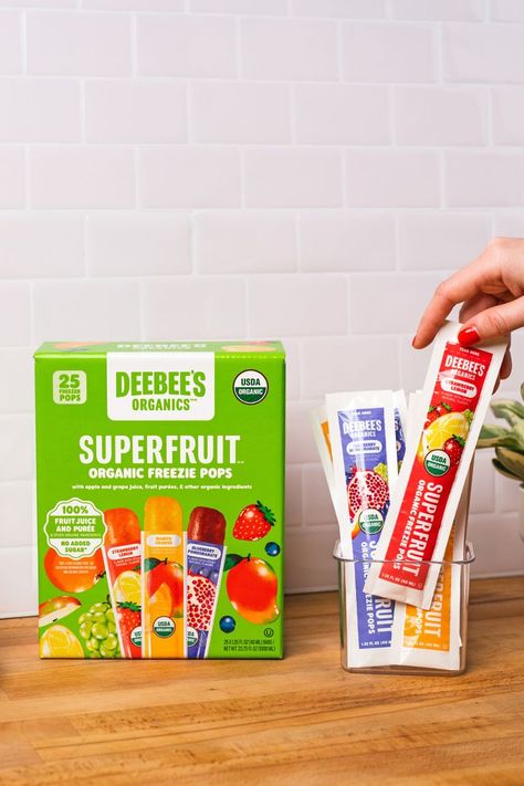 This image displays a box of DeeBee's Organics Classic SuperFruit Freezies and an acrylic box of DeeBee's Organics Classic SuperFruit Freezies tubes. There is a hand grabbing the strawberry lemon flavor. the flavors are strawberry lemon, blueberry pomegranate, and mango. Freezer Pops, Cream Packaging, Ice Cream Packaging, Homemade Popsicles, Strawberry Lemon, Grape Juice, Summer Refreshments, Action Plan, Summer Treats