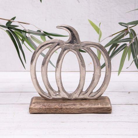 "Minimal yet striking—this metal pumpkin sculpture brings rustic charm with a modern touch! 🍁✨ Whether on a mantel or as a centerpiece, it’s the perfect fall decor addition. Handcrafted with attention to detail, it’s both timeless and chic. 🎃🖤 #FallDecor #RusticElegance #MinimalistDesign #PumpkinVibes #AutumnAesthetic #HandcraftedBeauty #UniqueDecor #MetalArt #ModernFallDecor #HarvestSeason #TimelessStyle #ArtisticPumpkin" Hallowwen Decor, Pumpkin Sculpture, Halloween Cut Outs, Cactus Candles, Modern Fall Decor, Silver Pumpkins, Kitchen Accessories Storage, Metal Pumpkins, Outdoor Clock