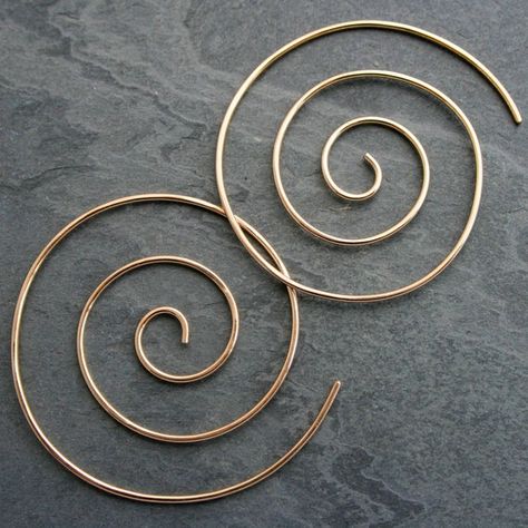 Large 14k Gold Fill spiral earrings. Hand formed and hammered, these spiral earrings are light and lovely. Thread them through your earlobe starting from the back, keep going until the post is behind your ear for an unbroken spiral look. Spirals are approximately 1 5/8" across. Handmade of 14k Gold Fill.I use durable, high quality 14k Gold Fill to make these earrings. The quality of gold-fill is greater than gold-plated or gold vermeil. 14 karat gold-fill has an actual layer of karat gold, not j Swirl Earrings Spirals, Spiral Hoop Earrings, Funky Silver Earrings, Spiral Jewelry, Silver Threader Earrings, Earring Hole, Swirl Earrings, Spiral Earrings, Funky Jewelry