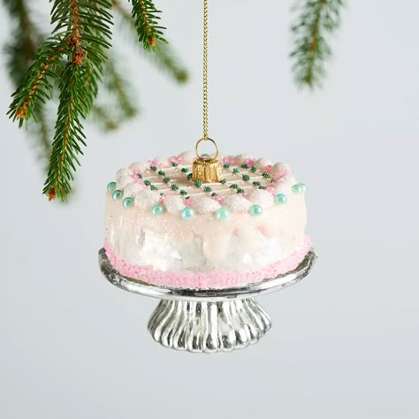 A fun addition to Christmas trees, stockings, desktops and more, our pink cake ornament features lovely pink frosting details and a silvery cake stand. Our ornament is made from beautiful, blown glass and is painted by hand, making it a piece worth keeping for years to come. Food Ornaments Christmas Tree, Dessert Ornaments, Girly Christmas Decor, Table Ornaments, Unique Ornaments, Pink Frosting, Food Ornaments, Fun Ornaments, Christmas Time Is Here