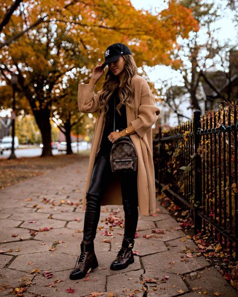 Fashion blogger mia mia mine wearing a camel coat with faux leather pants and louis vuitton wonderland combat boots. Visit my blog to see more chunky boots outfits, combat boots outfits, and edgy fall outfits for women. #casualootd #lookoftheday #combatboots Fall Fashion Colors, Combat Boot Outfit, Express Sweater Dress, Mia Mia Mine, Vinyl Leggings, Walking In Heels, Mia Mia, Look Rock, Louis Vuitton Boots