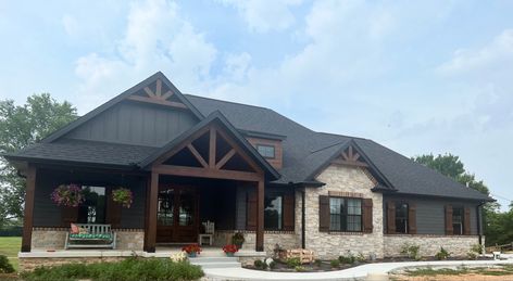 Dark House Exterior Ranch Style, Dark Mountain House Exterior, Dark Colored Ranch Style Homes, Dark Brown Ranch House Exterior, Black Ranch House, Dark Modern Farmhouse Exterior With Stone, Dark Siding, Dark Exterior House, Moody Farmhouse