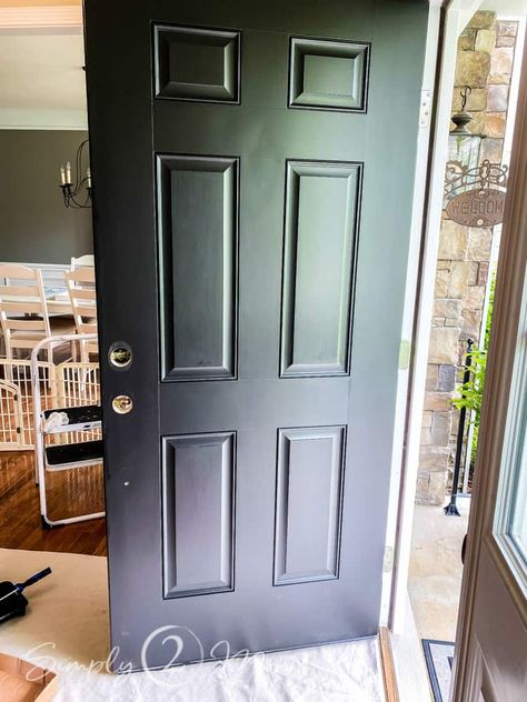 Is your front door looking a little drab? Want to make a good first impression? Come see how we updated our front entry with a simple and affordable front door makeover. #frontdoor #blackdoor #entryway #frontporch #diy #makeover #painteddoor Diy Black Front Door, Painting A Steel Entry Door, Front Door Upgrade Diy, Diy Front Door Makeover Ideas, Builder Grade Front Door Makeover, Front Door Replacement Before And After, Black Paint For Front Door, Metal Front Door Makeover, Paint Front Door Black