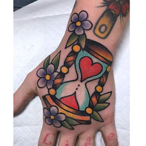 Marianne Savard on Instagram: “#hourglass #hourglasstattoo #traditionaltattoo #handtattoo #flowers #flowertattoo #hearttattoo #tradworkerssubmission 🌸🌸” Hourglass Tattoo Traditional Black, Small Hourglass Tattoo, Traditional Hourglass Tattoo, Chris Tattoo, Diary Drawing, Rockabilly Art, Hourglass Tattoo, American Traditional Tattoo, American Traditional