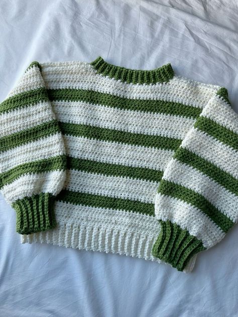 This beginner-friendly crochet blanket is easy to follow and creates a beautiful and cozy blanket for your home. We also offer a variety of free and paid crochet patterns on other topics.. #Striped_Crochet_Pullover #Green_And_White_Crochet_Sweater #Chunky_Crochet_Pullover_Pattern_Free #Crochet_Cozy_Sweater Green And White Crochet Sweater, Crochet Sweater One Piece, Stripped Sweater Crochet, 2 Color Crochet Sweater, Crochet Sweater Striped, Free Crochet Patterns For Clothes, Two Color Crochet Sweater, Women Crochet Sweater, Crochet Sweater Fall