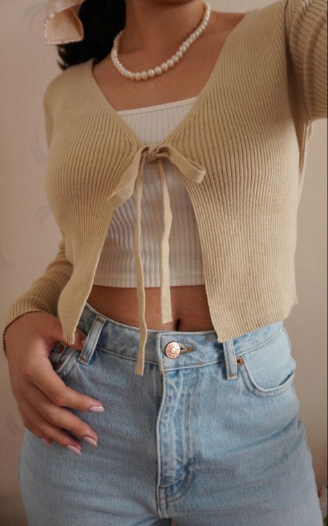 I love this outfit. It shows a preppy minimalist look for young girls that are trying to find for cute outfits. #beige #beigeaesthetic #pearls #outfits #clothes #cardigan Small Cardigan Outfit Aesthetic, Tiny Cardigan Outfit, Beige Cropped Cardigan Outfit, Little Cardigan Outfit, Light Cardigan Outfit, Cropped Cardigan Outfit Aesthetic, Small Cardigan Outfit, Tight Cardigan Outfit, Khaki Cardigan Outfit