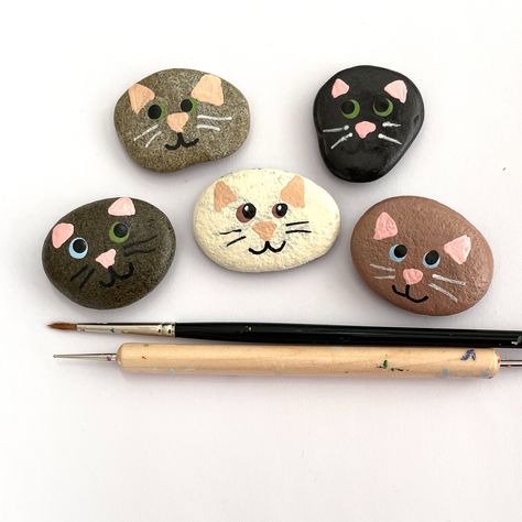 Add some feline charm to your home with these adorable kitty pebbles!   Perfect for cat lovers, these hand-painted pebbles are part of my Cool for Cats Collection.   Get your paws on this set of 5 now in my online shop!     To purchase some of my painted rocks, you can use my shop's website link: creationsjdb.com/shop-hand-crafted-art-stones/  #catlovers #coolcats #handpaintedpebbles Rock Painting Cats Easy, Simple Stone Painting, Pet Rock Painting Ideas, Cat Stone Painting, Cats Painted On Rocks, Painted Rock Cat, Rock Painting Cats, Stone Painting Animals, Painted Rocks Cats