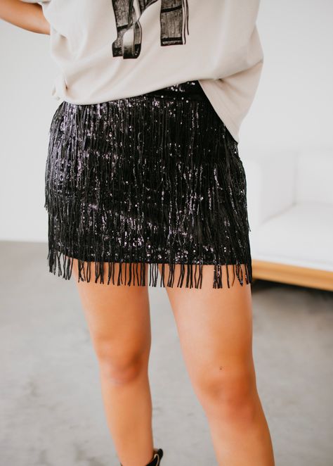 This Western-inspired mini skirt boasts sequin and fringe accents, adding a touch of bohemian flair to your wardrobe. The perfect blend of style and influence, this skirt is a must-have for any fashion-forward individual. Brittany, Laurie and Serenity are wearing size smalls. Measurements: Body Length: 17.5" Small: Waist: 26" Medium: Waist: 28" Large: Waist: 30" Self: 95% Polyester 5% Spandex Lining: 100% Polyester Sequin Mini Skirt Outfit, Sequin Fringe Skirt, Fringe Mini Skirt, Tassel Skirt, Miniskirt Outfits, Sequin Mini Skirts, Fringe Skirt, Curvy Dress, Skirt Outfit