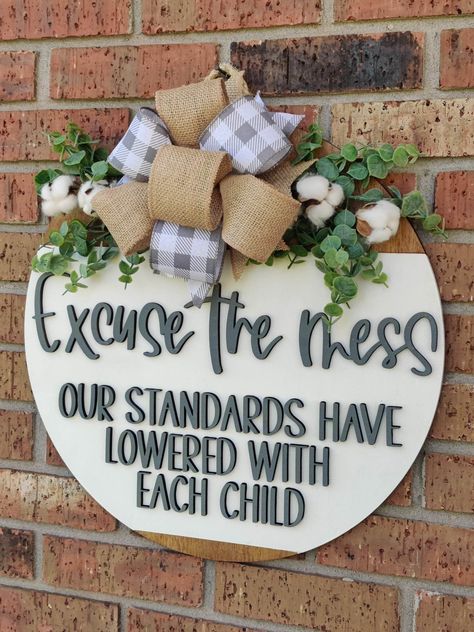 Excuse the mess our standards have lowered with each child door round This sign gives the perfect funny touch to your door! It makes a great housewarming, anniversary, or wedding gift. They come in a variety of sizes so they are perfect to fit whatever space you have in mind. Colors can be changed to your liking and I will ensure the bow matches the new color scheme. Please message if you would like to change the colors. Our sizes are  12 inch 16 inch 18 inch Each one is lasered out of 1/4 inch wood, hand painted, personalized, sealed, and topped with a beautiful bow to match and greenery. Bow and greenery may vary depending on availability! We pride ourselves in excellent turn around time. Each sign is made in the order it is received. Please allow 1- 2 weeks for us to complete your order Funny Door Hangers, Cricut Tricks, Funny Welcome Signs, Funny Door Signs, Welcome Door Sign, Hanger Ideas, Round Signs, Board Signs, Welcome Door Signs