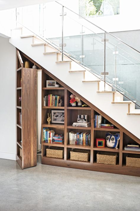 a bookshelf with books and a basket on it Door Under Stairs, Stair Bookshelf, Stairs Furniture, Architecture Room, تحت الدرج, Stair Shelves, Murphy Door, Stairs Renovation, Secret Hideaway