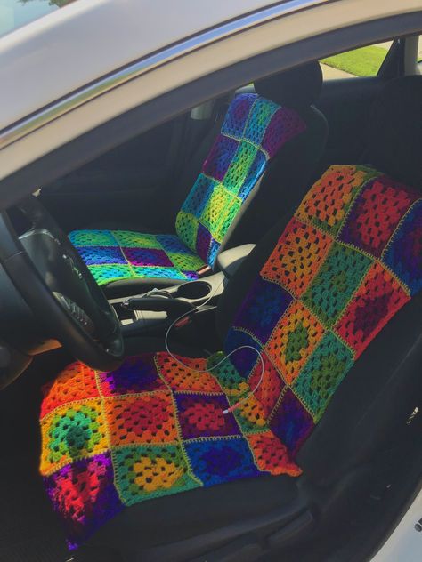 front seat of car with bright, colorful seat covers. Crochet Seat Covers For Car, Crochet Car Ideas, Crochet Car Decorations, Crochet Seat Cover, Crochet Car Decor, Crochet Car Seat Cover, Car Crochet, Aesthetic Car Accessories, Car Interior Diy