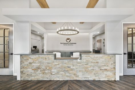 Stone, wood beam, board and batten siding and a metal accented roof make up this ground-up 3,316 sqft. dental office featuring 7 operatories. In classic Americana style, traditional, clerestory, and accent windows on the front façade establish a rectilinear visual hierarchy. Dental Office Reception, Office Reception Desk Designs, Luxury Colors, Chiropractic Office Design, Office Reception Desk, Doctor Office Design, Orthodontic Office, Dentist Office Design, Optometry Office