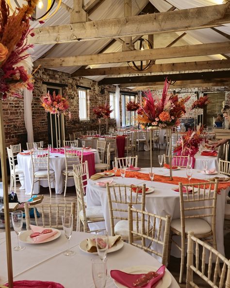 Orange and Pink Wedding Flowers. Set in the beautiful chamblesforth hall and grange. This style was mixed with dried and artificial flowers, and finished with bright pink and orange pampas grass. The table centerpieces were displayed on gold plinths from @kcoevents Added extras finished by the bride 😍 #smallbusinessyorkshire #yorkshiresmallbusiness #weddingcenterpieces #pinkorange #pinkorangewedding #pampascenterpiece #weddingdecor #selby #camblesforthhall #camblesforthhallandgrangewe... Pink And Orange Wedding Table Setting, Pink And Orange Wedding Reception, Bright Orange Wedding Theme, Pink Orange Wedding Theme, Burnt Orange And Pink Wedding, Pink And Orange Table Setting, Pink Autumn Wedding, Pampas Centerpieces, Pink And Orange Wedding Theme