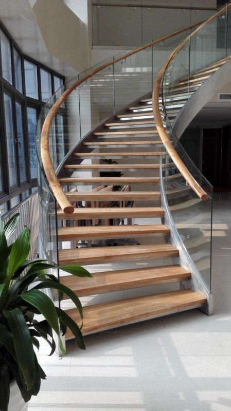 Stairs Design Curved, Steel Curved Staircase, Curved Staircase With Glass Railing, Helical Staircase Design, Glass Curved Staircase, Glass Railing Stairs Stainless Steel, Curve Stairs Design, Curved Stairs Design, Curved Stair Railing