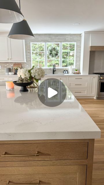 Ally • Home Inspo on Instagram: "Save this NOW & comment DETAILS for the color info to be sent to your DM!  I get this question ALL the time! 🤩  Our quartz is by Hanstone in the color Montauk.  It is the prettiest shade of white with soft gray and caramel veining + pearly specs throughout.  It works perfectly with a soft white kitchen with wood accents…but is also white enough to work well with cabinets that are a brighter white.   In terms of pricing/cost, this is actually on the mid-lower end when it comes to quartz and I was pleasantly surprised!   I also love how there is veining in the slabs but it isn’t too bold or trendy.  What do you think!?   Any questions?  Just comment 👇🏻   #kitcheninspirations  #newkitchen  #quartzcountertops  #newcountertops  #kitchencountertops  #kitchende