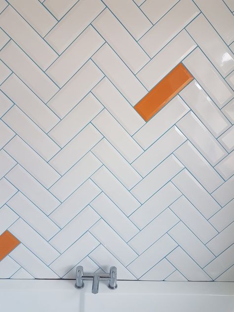 White metro tiles in a Herringbone pattern with blue grout. And a few random orange tiles. This is my new bathroom White Tiles Blue Grout, Metro Tile Patterns, White Tile Blue Grout Bathroom, White Tile Blue Grout, Coloured Grout Bathroom, Blue Orange Bathroom, Orange Grout, Colour Grout, Blue Grout