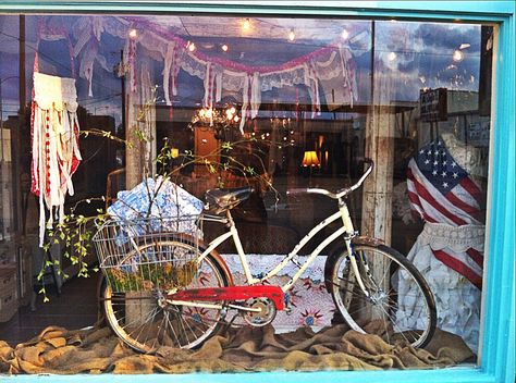 Summer window display. Vintage bicycle, American flag, string lights. Farms Market, Bicycle Display, Bookstore Ideas, Summer Display, Summer Window Display, Bike Craft, Windows Display, Summer Window, Old Bicycle