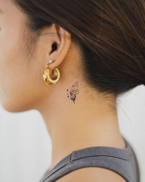 Explore the intricate world of small tattoos with our detailed guide. From choosing designs to finding the perfect spot, get ready to ink your story. Back Ear Tattoo, Tattoo Papillon, Tiny Butterfly Tattoo, A Small Tattoo, Butterfly Neck Tattoo, Small Neck Tattoos, Behind Ear Tattoos, Vogel Tattoo, Small Girly Tattoos