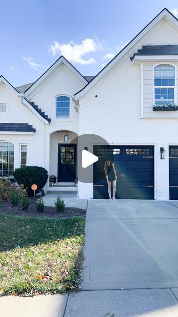 Lauren Jansen | DIY on Instagram: "I did it!! I painted the garage doors black and… I LOVE THEM. I didn’t think I would honestly. I thought it would be too much for this home. But I think they ground and balance the house in such a nice way. The copper hardware doesn’t hurt either 🤌 oh and painting them wasn’t hard at all! Here’s how I did it… I started by removing the old hardware, cleaning the doors, and taping around the trim. Then I used a bonding primer (zinsser bondz) before applying two coats of Sherwin Williams Everlast paint in Tricorn Black with a flat finish. Make sure you remove the tape while the paint is still wet and raise the garage doors halfway for the paint to dry without the panels sticking together. I also scraped my windows clean with a razor blade instead of tap Garage Door Makeover Black, White Houses With Black Garage Doors, Front Door And Garage Door Ideas, White House Black Trim Brown Garage Door, Black Garage Door Tan House, Garage Painted Black, Black Painted Garage Doors, Black Garage Doors White House, Urbane Bronze Sherwin Williams Exterior Garage Doors