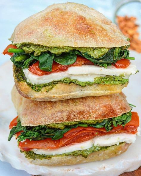 VEGAN tomato & mozzarella sandwich by @alexafuelednaturally Recipe: Ingredients: 2 Mini Ciabatta breads or vegan focaccia 1 vegan mozzarella 2 large tomatoes 1 cups spinach AVO PESTO: 1 Cup Fresh Basil 1/2 Avocado 1/2 Cup Water 1/4 Cup Nutritional Yeast 1/4 Cup Pine Nuts or raw almonds 2 Cloves Garlic Juice of 1 lime or lemon Salt pepper to taste you can make this even easier and buy a store bought vegan pesto like one from Trader Joes Directions: 1. Preheat oven to 350 degrees F. 2. Halve the t Tomato Mozzarella Sandwich, Ciabatta Sandwich, Salad Appetizer Cups, Mozzarella Sandwich, Pesto Sandwich, Vegan Mozzarella, Grape Salad, Vegan Pesto, Ciabatta Bread