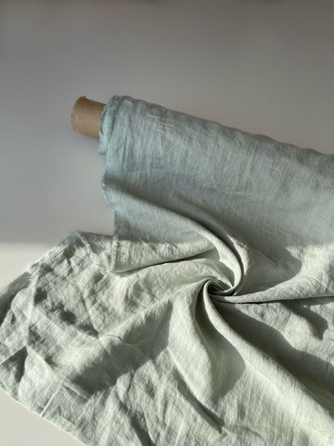 "Shop our high-quality linen fabric by the yard or meter. Softened, pre-shrunk linen fabric cut-to-length. Durable, absorbent, thermoregulating linen fabric can be used for sewing bed linens, bath, kitchen, table textiles, linen apparel, and more. Our high-quality linen fabric will give a touch of elegance and minimalism to your home. Not just a practical product- it also makes a great gift for any occasion, such as birthday, Christmas, bridal shower, newlywed, housewarming, realtor gift, hostes Linen Colors Fabric, Fresh Linen Aesthetic, Linen Fabric Photography, Sage Linen Curtains, Linen Fabric Green, Fabric Photography, Thrift Haul, Natural Linen Fabric, Realtor Gifts