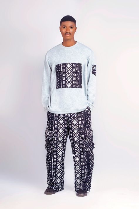 Discover the essence of african fashion with our grey african cargo sweatshirt & pants. this exceptional ensemble seamlessly combines comfort, style and culture, making it a true representation of the vibrant african spirit.   customization: embrace the beauty of customization with front and side pockets adorned in exquisite ankara material. the long pants also feature pocket details, adding a touch of functionality and flair to your outfit.   how and when to use: this two-piece set is the epito Ankara Dress Designs Men, Men Ankara Styles, Adire Styles For Men, Ankara Men Styles, Latest Ankara Designs For Men, Latest Ankara Styles For Men, Ankara For Men African Style, Ankara Trouser For Men, Ankara Dress Styles For Men