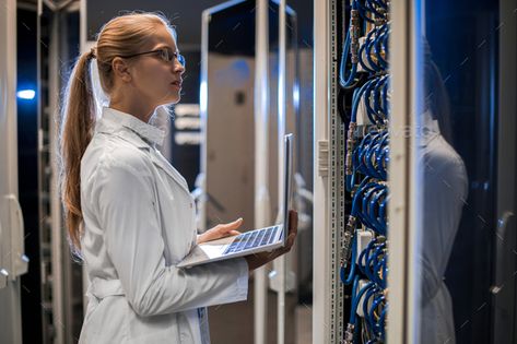 Female Scientist Working with Supercomputer by seventyfourimages. Side view portrait of blond female scientist wearing lab coat using laptop while working with supercomputer standing ... #Affiliate #view, #Side, #blond, #portrait Nuclear Engineering, Earth Gravity, Stepford Wives, Iphone Secrets, Military Tactics, Women Scientists, Social Media Buttons, Own Character, Sql Server