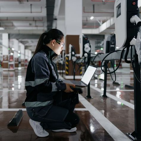 Asian female engineer installing charging station in parking lot Journeyman Electrician, Engineer Girl, Female Engineer, Student Survey, Hard Working Women, Ev Chargers, Dream Vision Board, Automotive Engineering, Carroll Shelby