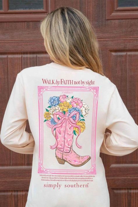 This Simply Southern Long Sleeve Walk By Faith T-Shirt for Women in Whisper is perfect for this Fall weather. This shirt features an adorable graphics, long sleeves, and lightweight construction. Features: Simply Southern Style: LS-WALK-WHISPER Color: Whisper 100% Cotton Simply Southern Shirts Long sleeves, crew neckline Simply Southern logo on sleeves, logo tag on hem Simply Southern logo and boot graphic on the left chest On the back: Country frame and boots with flowers and reads, “Walk by Faith not by sight” with a scripture verse above the Simply Southern logo Measurements from size small: Length from center back: 30” Chest: 38” Machine wash cold, tumble dry low Cute Christian Shirts, Jesus Merch, Southern Logo, Holding A Bouquet Of Flowers, Golden Poppy, Womens Christian Shirts, Christian Clothes, Color Whisper, Uplifting Phrases