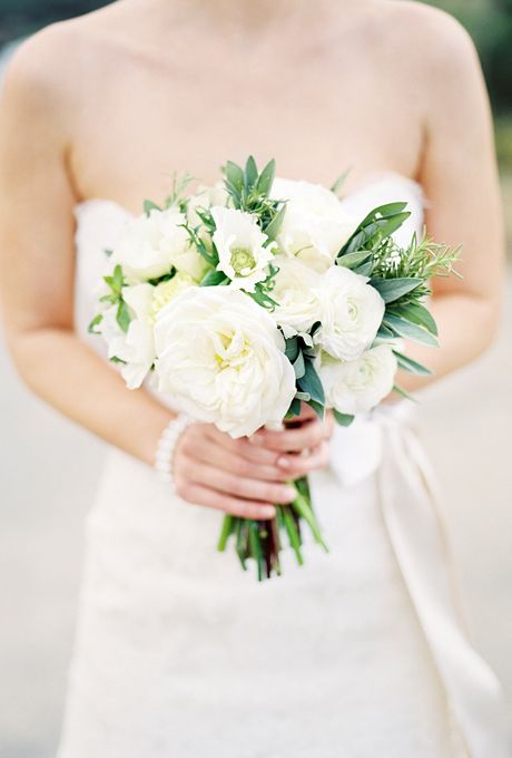 Brides.com: All-White Wedding Bouquets. A Rustic Bouquet Accented with Fresh Herbs. Floral designer Holly Vesecky, of Hollyflora in Los Angeles, designed this posy for a bride getting married on a mountaintop vineyard, "though the design is fairly universal," she says. She used white peonies, garden roses, lysimachia, anemones, and ranunculus to create an informal arrangement accented with green herbs (sage, rosemary, and oregano—yum!). See more rustic wedding flower ideas. Brides Wedding Bouquets, Wedding Bouquets Diy, Herb Bouquet, Bridesmaids Photo, Succulent Bouquet Wedding, Bride Rings, Wedding Flower Guide, Bouquets Diy, White Bouquets