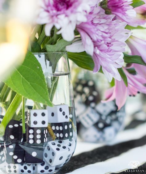 Game night flower centerpiece idea with dice as rocks in the vase #gamenight #partyideas #adultgames #partyactivities #hosting #entertaining #gametheme #pokertheme #pokernight #flowerarrangement #floralideas #centerpiece #dice Games Night Ideas For Adults, Games Night Ideas, Game Night Table, Adult Game Night Party, Game Night Decorations, Games For Ladies Night, Adult Game Night, Lady Games, Board Game Party