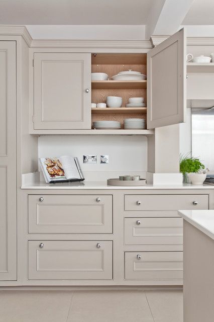 a delicate greige kitchen with shaker cabinets, white stone countertops and a matching sleek backsplash, simple knobs is a lovely idea Greige Kitchen Cabinets, Küchen In U Form, Beige Kitchen Cabinets, Greige Kitchen, Taupe Kitchen, Kitchen Ikea, Beige Kitchen, Coastal Kitchen, Kitchen Cabinet Colors