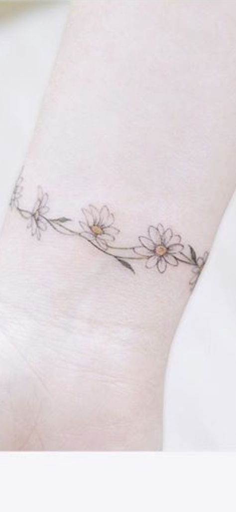 Daisy Ring Tattoo, Daisy Chain Anklet Tattoo, Daisy Chain Bracelet Tattoo, Daisy Ankle Tattoos For Women, Daisy Bracelet Tattoo, Flower Anklet Tattoos, Daisy Chain Tattoo Ankle, Wrist Wrap Tattoos For Women, Flower Bracelet Tattoo