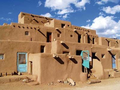 The Taos Pueblo in northern New Mexico is the oldest continuously occupied structure on the continent. Dating back to a.d. 1000, its adobe walls today house about 150 Taos Native Americans who maintain the ancient traditions of their ancestors. The Pueblo is not a historical artifact or a re-creation; it is an actual town that offers a fascinating introduction to Native American life. New Mexico Style, Travel New Mexico, Taos Pueblo, Blue Doors, Taos New Mexico, Vernacular Architecture, Land Of Enchantment, Natural Building, Doors And Windows