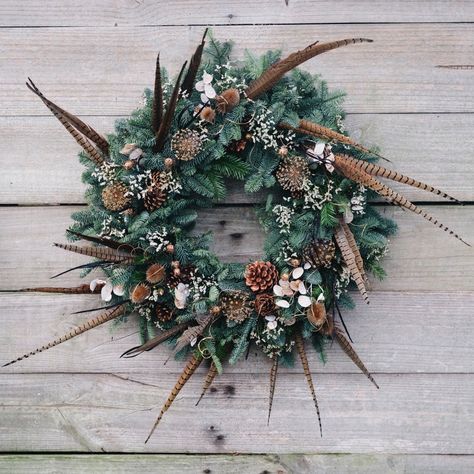 Large wild garden style wreath with pheasant feathers, pine cones, allium, nigella and teasle dried seed heads Wreath With Pheasant Feathers, Pheasant Feather Decor, Stable House, Fun Wreaths, Feather Arrangements, Wreath Workshop, Natural Christmas Wreaths, Eco Christmas, Feather Wreath