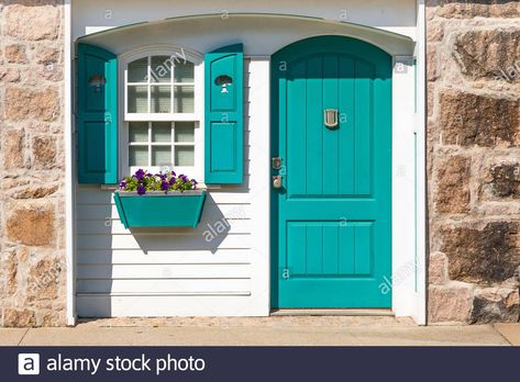 Partial front exterior of white cottage with teal shutters and door and teal window box with purple petunias on bright sunny day Stock Photo Talavera House, Teal Shutters, Front Door Colours, Cottage Front Door, Front Door Images, Teal Front Doors, Sign With Flowers, Turquoise Cottage, Teal Door