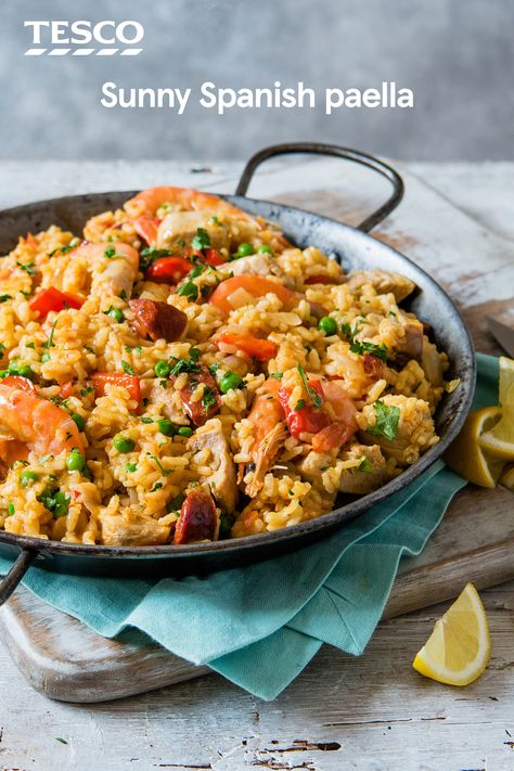 Cook up some Spanish sunshine with our classic paella recipe. Packed with chorizo, chicken, prawns and veg, this simple recipe gets it's vibrant colour from sweet saffron and smoky paprika. | Tesco Chorizo Chicken, Spanish Paella Recipe, Easy Paella, Paella Recipe Seafood, Spanish Paella, Paella Recipe, Seafood Paella, Tesco Real Food, Spanish Dishes