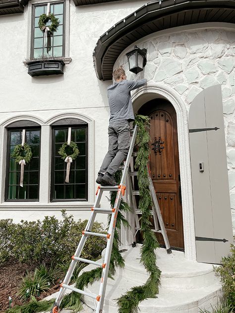 Heights House Christmas Exterior Stone House Christmas Decorations Exterior, Christmas Wreath Exterior Window, Classic Christmas Exterior, Christmas Exterior Window Decorations, House With Wreaths On Windows, Classy Exterior Christmas Decor, Christmas Wreaths Windows Outdoor, Wreaths On House Windows, Colonial Christmas Exterior