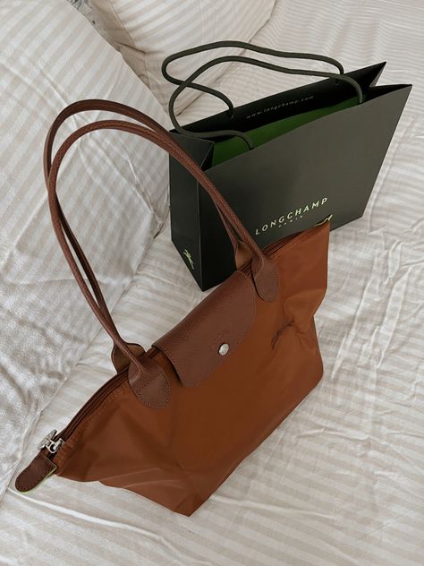 1/21/23 Longchamp Le Pliage Brown, Brown Longchamp Bag, Longchamp Cognac, Longchamp Aesthetic, Longchamp Bag Outfit, Longchamp Outfit, Uni Bag, French Luxury Brands, Wallpaper Iphone Disney Princess