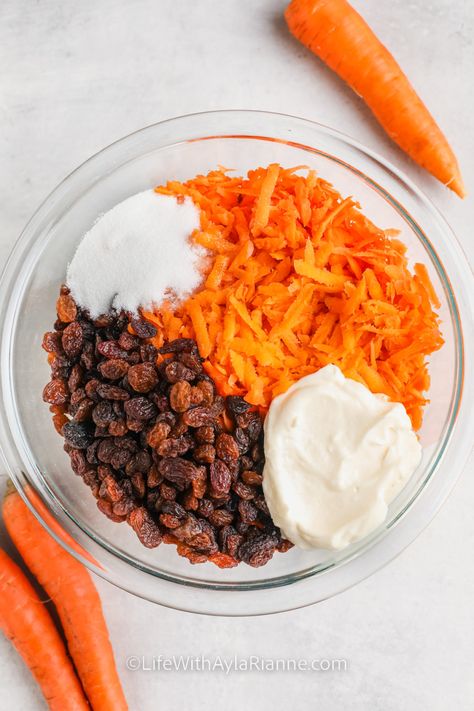 ingredients in a bowl to make Carrot and Raisin Salad Creamy Carrot Salad, Luby's Carrot Raisin Salad, Carrot Salad With Raisins Pineapple, Carrot And Raisin Salad, Raisin Salad, Carrot Raisin Salad, Carrot Salad Recipes, Spinach Salad Recipes, Cranberry Salad