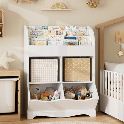 Keep all of your kiddo's favorite books, toys, and stuffed animals within reach with this 35'' bookshelf. With its scalloped details, it shows off a vertical design, complete with four shelves and two compartments, offering ample room for your favorite novels, decorative accents, and more. Made from engineered wood, this bookshelf has a finished back and a three-tier structure that adds visual interest to your room. We love that it comes with a wall anchor device for added safety. With its blend of form and function, this bookshelf is the ideal addition to your living room, bedroom, or home office. | Viv + Rae™ Kupang Cube Bookcase w / Display Shelf, White Wood in Brown / White | 35.1 H x 26.4 W x 15.7 D in | Wayfair Living Room And Playroom, Toy Storage Organizer, Bookcase With Drawers, Bookcase Display, Toy Storage Organization, Cube Bookcase, Corner Storage, Kids Bookcase, Bookshelves Kids