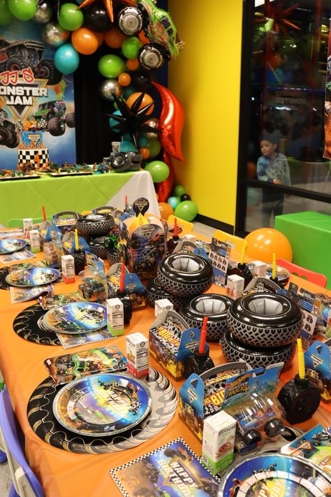 JJ's Monster Jam! JJ is Four! | CatchMyParty.com Monster Truck Party Table, Monster Truck Birthday Party Centerpiece, Monster Trucks Party Ideas, Monster Jam Balloons, Monster Truck Birthday Outfit, Cars And Monster Trucks Birthday, Monster Truck Birthday Table Decor, Monster Jam Birthday Party Decoration, Megladon Monster Truck Birthday Party