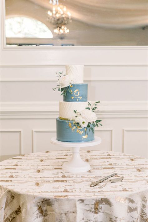 Romantic dusty blue and white wedding cake with gold foil Dusty Blue And Gold Wedding Centerpieces, Dusty Blue And Gold Wedding Cake, Dusty Blue And White Wedding Cake, Dusty Blue Cake Wedding, Wedding Theme Blue And Gold, Dusty Blue Wedding Cakes, Steel Blue Wedding Cake, Dusty Blue Cake, Dusty Blue Wedding Cake Ideas