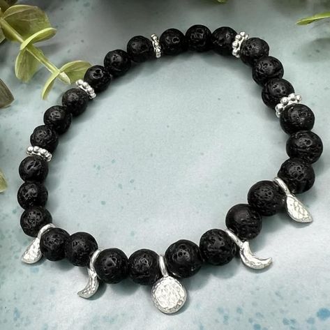 🌕✨ Celebrate the full moon with my stunning Diffuser Phases of the Moon Bracelet! 🌕✨ This beautiful bracelet is not only a stylish accessory but also a reminder of the ever-changing phases of the moon. Each little charm represents a different phase, from the waxing crescent to the full moon and beyond, allowing you to carry the lunar cycle with you wherever you go. 🌙✨ Made with quality Black Lava Beads & beautiful shiny Silver plated Phases of the Moon charms & spacers I use the best cord ... Elegant Moon Phase Bracelets, Elegant Silver Moon Phase Bracelet, Silver Spiritual Bracelets With Moon Phase, Celestial Silver Moon Phase Bracelets, Spiritual Moon Phase Bracelet, Moon Bracelet, Diffuser Jewelry, Boho Style Jewelry, Chic Jewelry