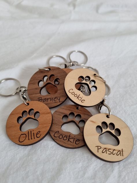 Paw print key chain  Personalised paw print key chain made from your choice of wood - Walnut, Maple or Cherry.  Make a beautiful addition to any set of keys and make an excellent gift for any animal lover. Made from wood giving it a solid feel and customised to make it personal for each pet. The centre paw print cut out to make it stand out even more. Make amazing gifts for any pet owner and a brilliant way to cherish the memory of a pet.  Laser cut from 3mm wood and supplied with a key chain to Glowforge Pet Projects, Wooden Key Chains, Custom Key Chains, Wood Cats, Wooden Keychain Ideas, Laser Cut Gifts, Laser Engraving Ideas Gifts, Laser Cut Gift Ideas, Lézervágott Fa