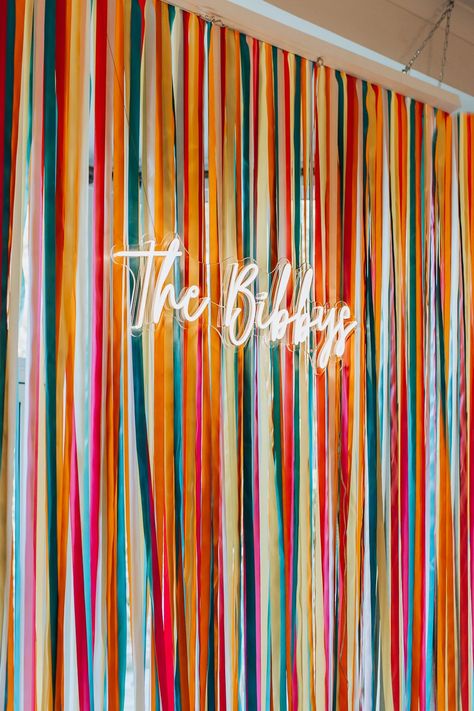 Wedding Backdrop For Photobooth, Colorful Party Backdrop, Neon Sign Backdrop Ideas, Ribbon Wedding Backdrop, Ribbon Wall Backdrop, Wall Decor For Wedding Reception, Creative Wedding Backdrop, Colorful Photo Backdrop, Colourful Wedding Backdrop