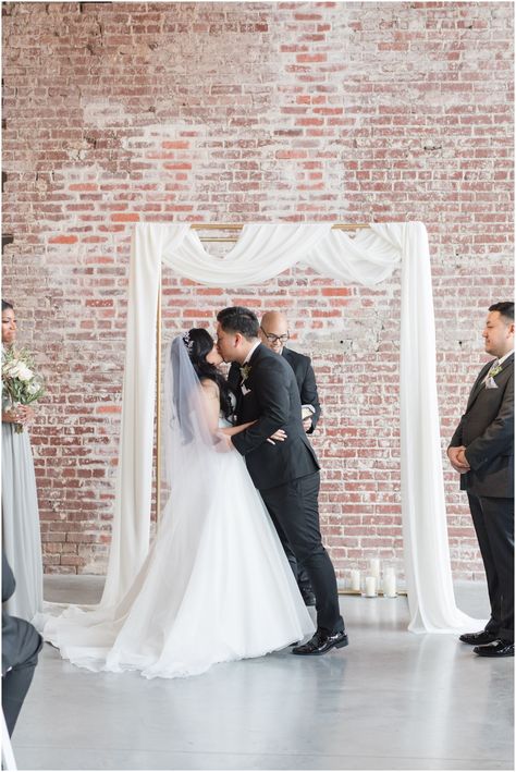 Simple Wedding Arch Indoor, Exposed Brick Wedding, Brick Wedding Venue, Wedding Ceremony Backdrop Indoor, Brick Wedding, Simple Wedding Arch, Modern Industrial Wedding, Simple Modern Wedding, Yellow Wedding Theme